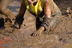 Woman running through mud